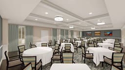 Bright banquet hall with round tables and chairs