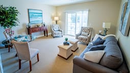 Bright staged living room with neutral decor