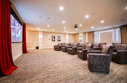 Private theater room with leather chairs and projector