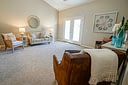 Neutral living room with French doors and leather chair