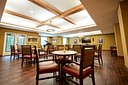 Spacious community dining room with piano and TV
