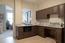 Modern kitchenette with dark wood cabinets and sink