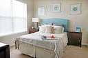 Bright bedroom with teal headboard and tray