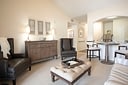 Modern living room with leather chairs and ottoman