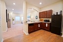 Cozy kitchenette with dark wood cabinets and granite counters
