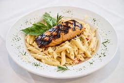 Grilled glazed salmon over creamy penne pasta