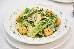 Caesar salad with croutons and Parmesan shavings