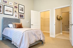 Cozy bedroom with gallery wall and open closet
