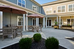 Apartment courtyard patio with tables and umbrellas
