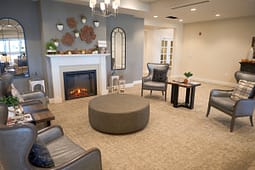 Cozy lounge area with fireplace and armchairs