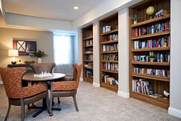 Cozy library with bookshelves and chess table