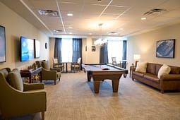 Modern lounge with pool table and seating area