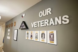 Wall display honoring veterans with framed photos
