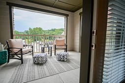 Cozy apartment balcony with chairs and outdoor rug