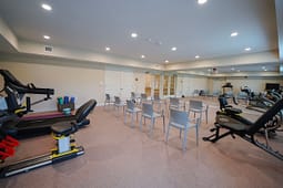 Fitness room with chairs and exercise equipment