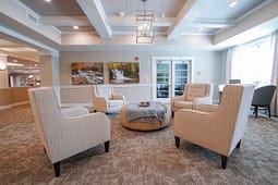 Modern lounge with armchairs and central ottoman