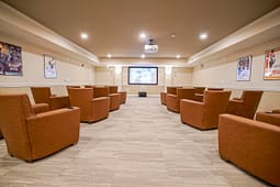 Cozy home theater with leather chairs and projector
