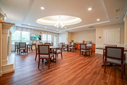 Bright communal dining room with tables and chairs