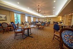 Elegant dining room with set tables and blue chairs