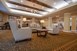 Elegant lounge with armchairs and wooden ceiling beams