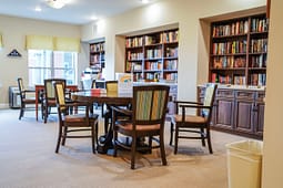 Cozy library reading room with table and bookshelves