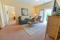 Bright living room with sofa and balcony doors