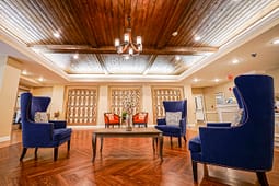 Elegant lobby with blue armchairs and wood ceiling