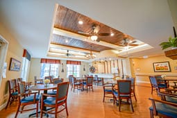 Spacious community room with tables and wooden ceiling