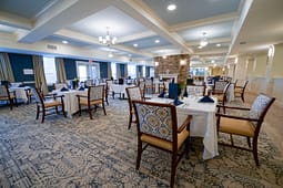 Elegant dining room with round tables and fireplace