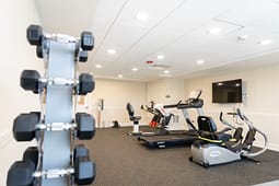 Small gym with treadmill and exercise bikes