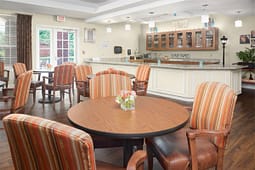 Cozy dining area with round tables and striped chairs