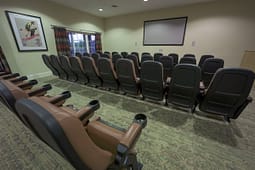 Small home theater with rows of reclining seats