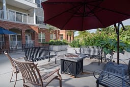 Apartment courtyard patio with benches and fire pit