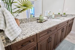 Modern bathroom vanity with granite countertop and wooden cabinets