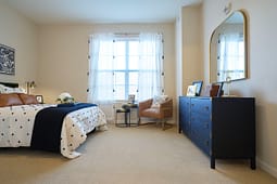 Modern bedroom with navy accents and large window