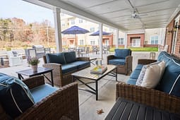 Covered patio with wicker seating and blue cushions