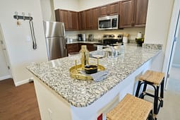 Modern kitchen with granite island and bar stools