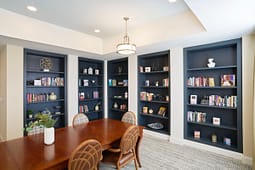 Modern dining room with built-in blue bookshelves