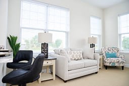 Bright living room with sofa and large windows