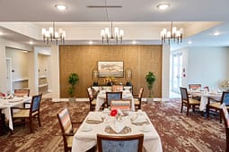 Elegant dining room with set tables and chandeliers