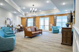 Bright modern lounge with leather sofa and armchairs