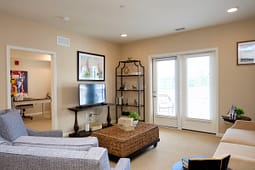 Modern living room with TV and wicker coffee table