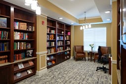 Cozy library room with bookshelves and armchairs