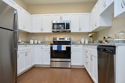 Modern white kitchen with stainless steel appliances