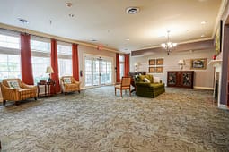 Spacious lounge with armchairs and chandelier lighting