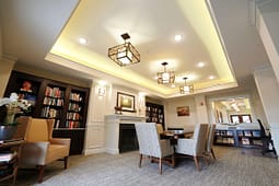 Cozy library lounge with fireplace and bookshelves