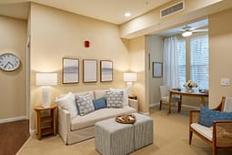 Cozy beige living room with sofa and dining area