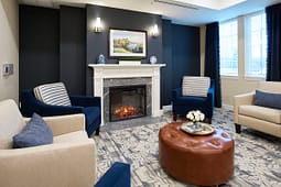 Cozy living room with fireplace and blue armchairs