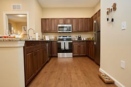 Modern kitchen with wooden cabinets and stainless appliances