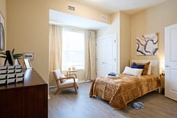 Cozy modern bedroom with single bed and armchair